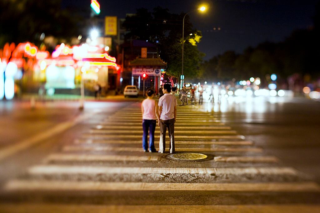 Dos personas transitando por las calles de Beijing, China, el 30 de junio de 2006