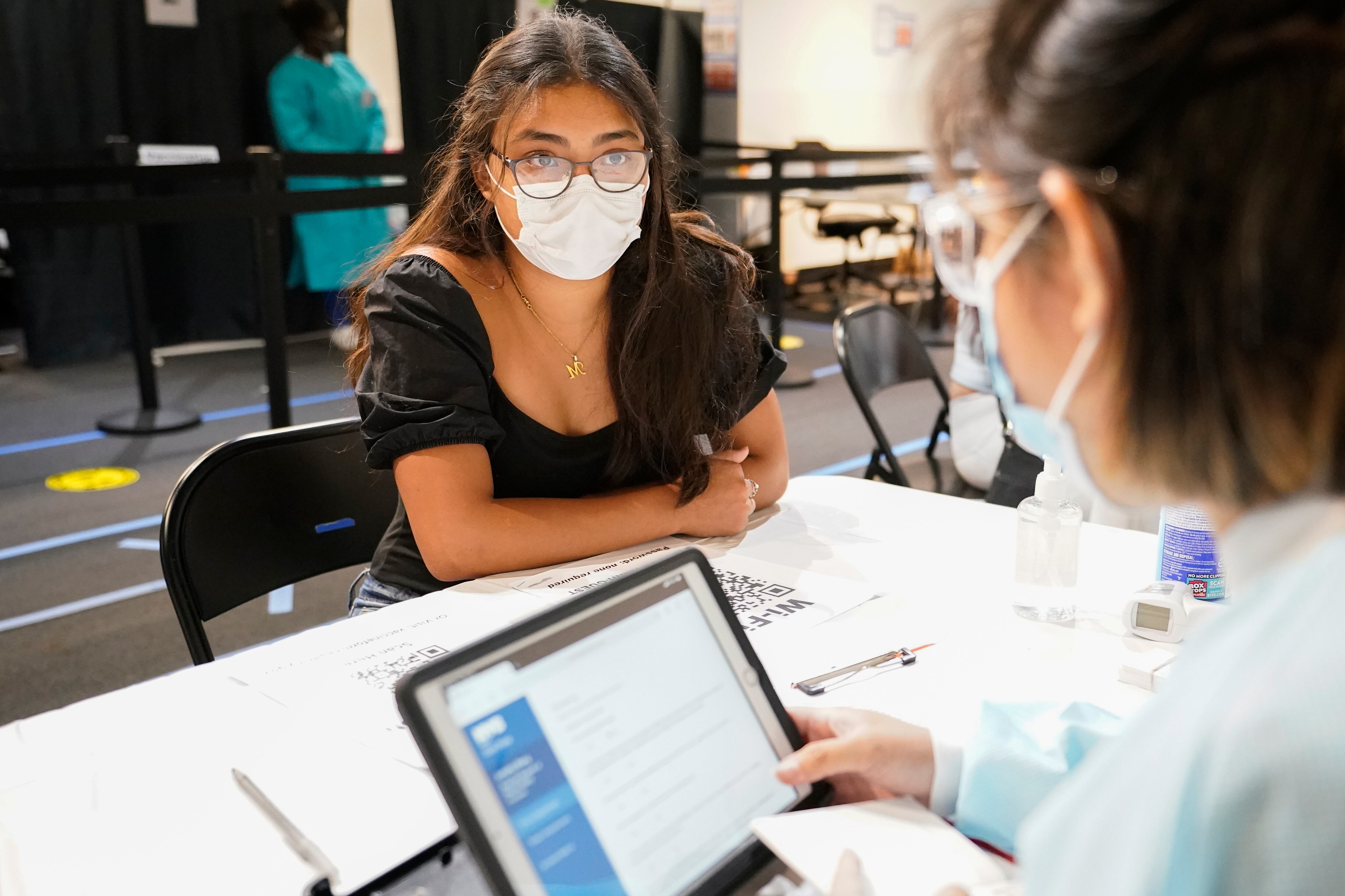 Persona con tapabocas informándose acerca de su salud.