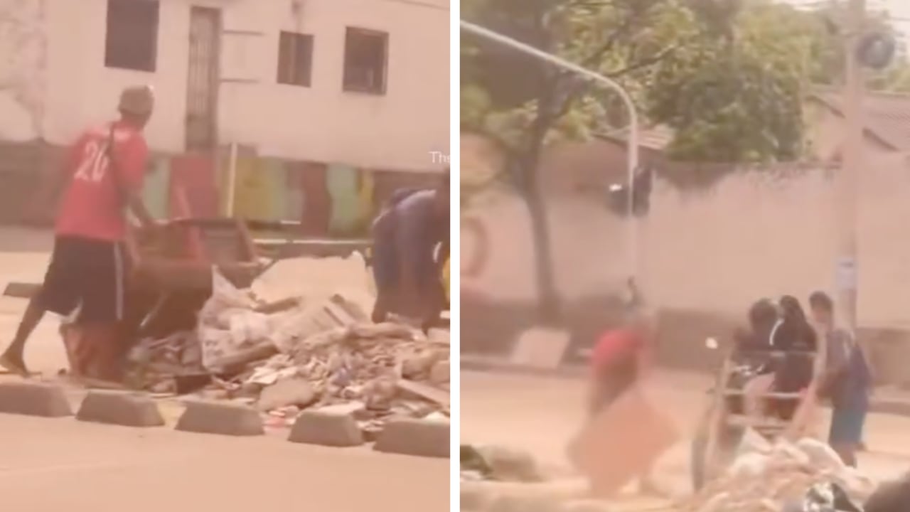 Hombres arrojando basura en vía pública en Barranquilla