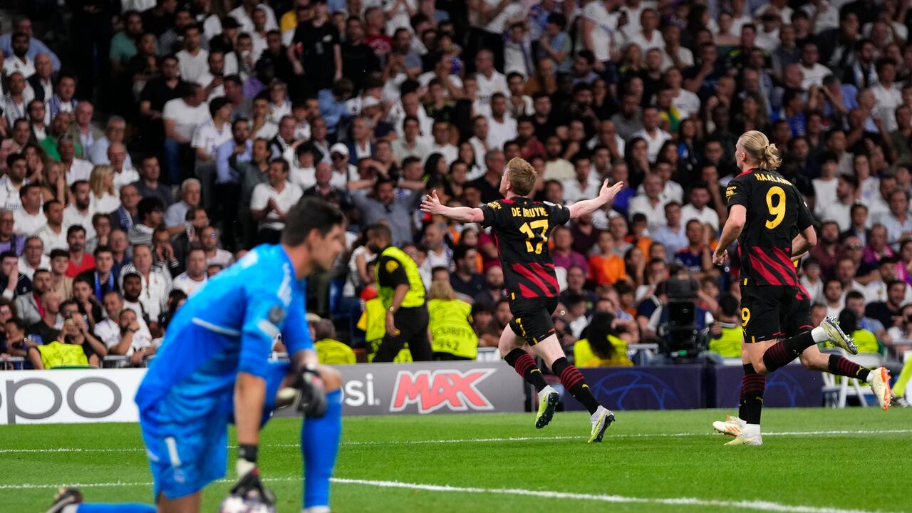 Manchester City's Kevin De Bruyne, center, celebrates after scoring his side's first goal during the Champions League semifinal first leg soccer match between Real Madrid and Manchester City at the Santiago Bernabeu stadium in Madrid, Spain, Tuesday, May 9, 2023. (AP Photo/Manu Fernandez)