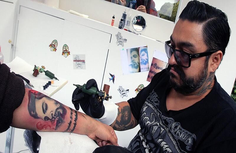 Una mujer se hace corregir el texto de su tatuaje durante el IV Festival de la Palabra, organizado por el Instituto Caro y Cuervo, que corrigió tatuajes con faltas de ortografía para así promover el buen uso del idioma español en Bogotá (Colombia).