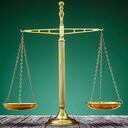 Law scales on wooden desk concept for justice and equality