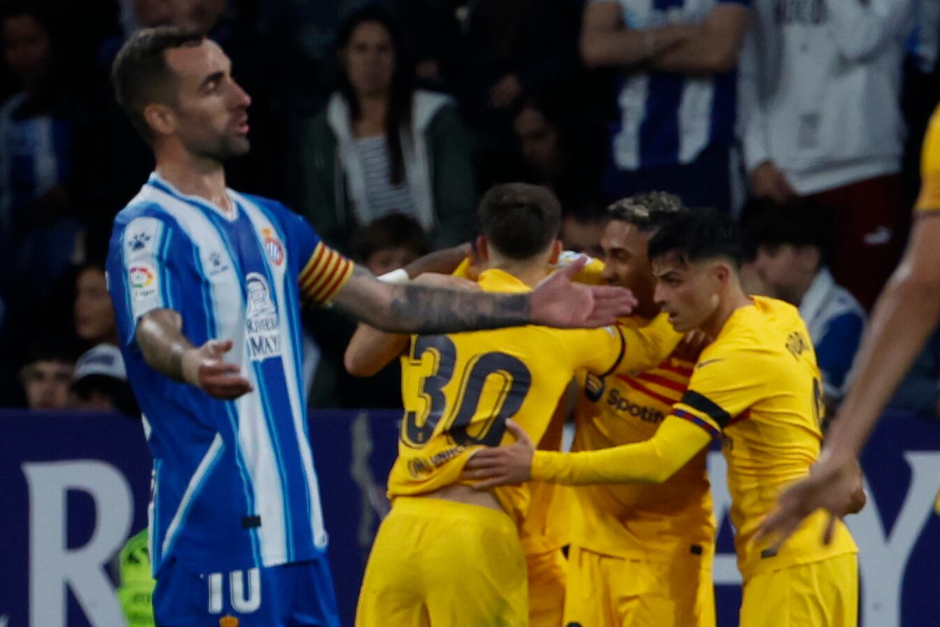 Barcelona players celebrate after Robert Lewandowski scored his side's third goal during the Spanish La Liga soccer match between Espanyol and Barcelona at the RCDE stadium in Barcelona, Sunday, May 14, 2023. (AP/Joan Monfort)