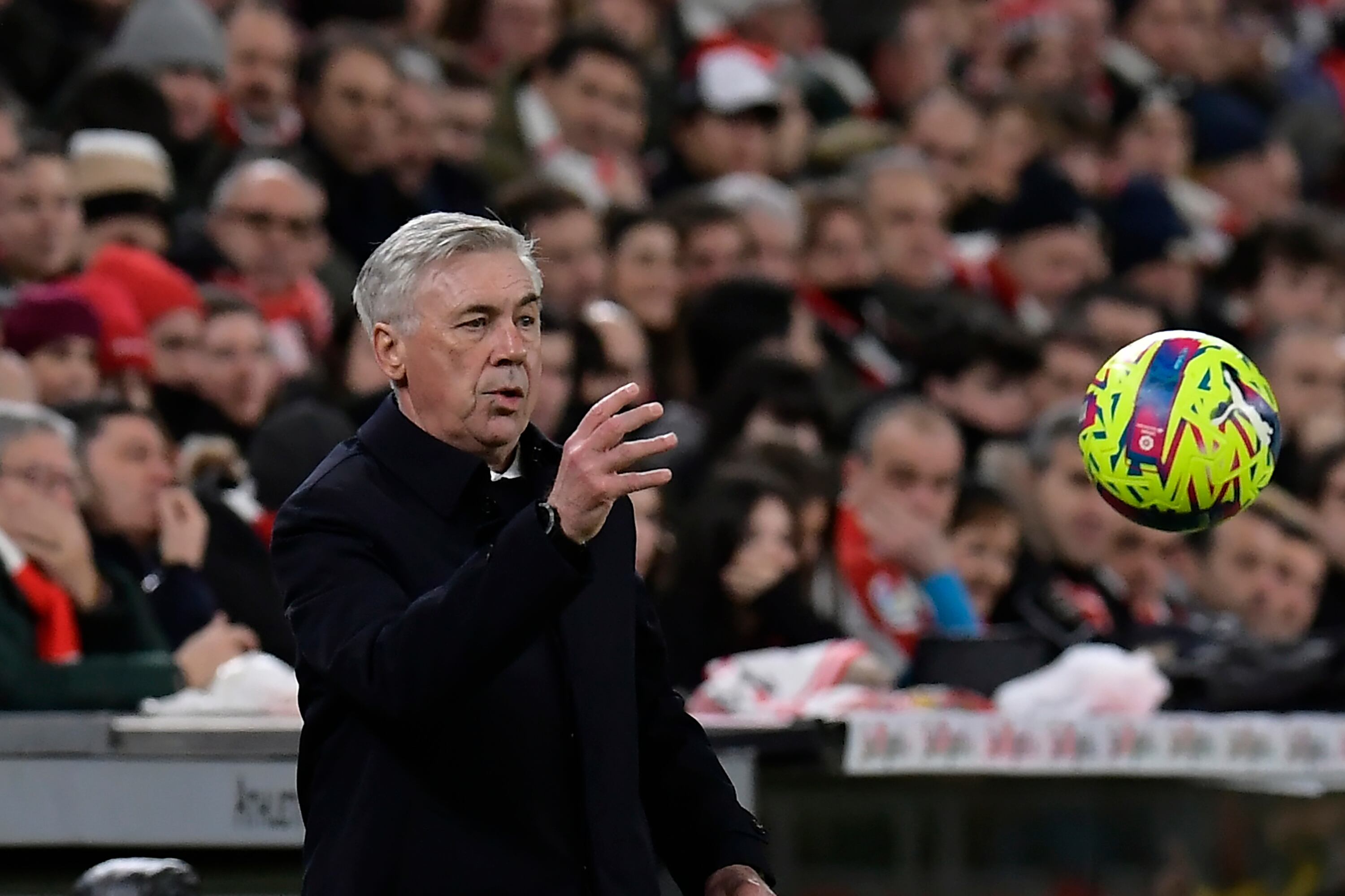 Real Madrid's head coach Carlo Ancelotti throws the ball during the Spanish La Liga soccer match between Athletic Club Bilbao and Real Madrid at the San Mames stadium in Bilbao, Spain, Sunday, Jan. 22, 2023. (AP Photo/Alvaro Barrientos)
