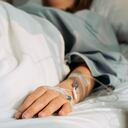 Asian woman lying sick in hospital.