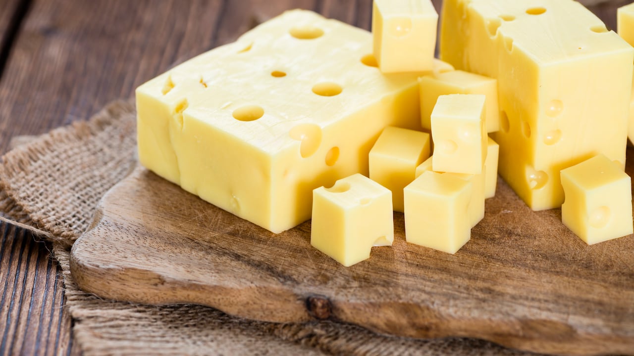 Portion of Cheese (close-up shot) on rustic wooden background