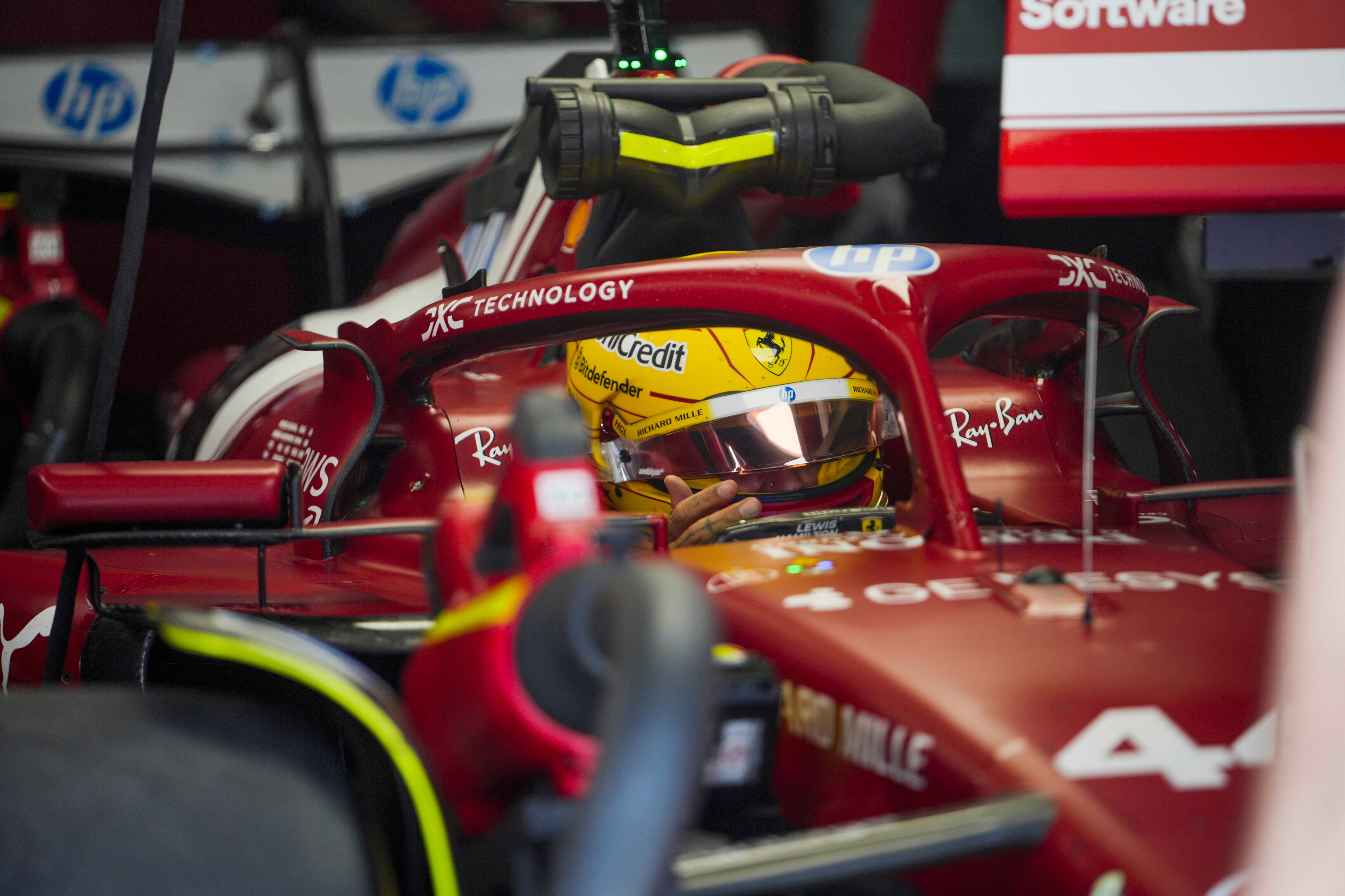 Ferrari driver Lewis Hamilton of Britain sits on his car at pits during the first free practice at the Shanghai International Circuit in Shanghai, China, Friday, March 21, 2025, ahead of the Chinese Formula One Grand Prix (Sunday). (AP Photo/Andy Wong)