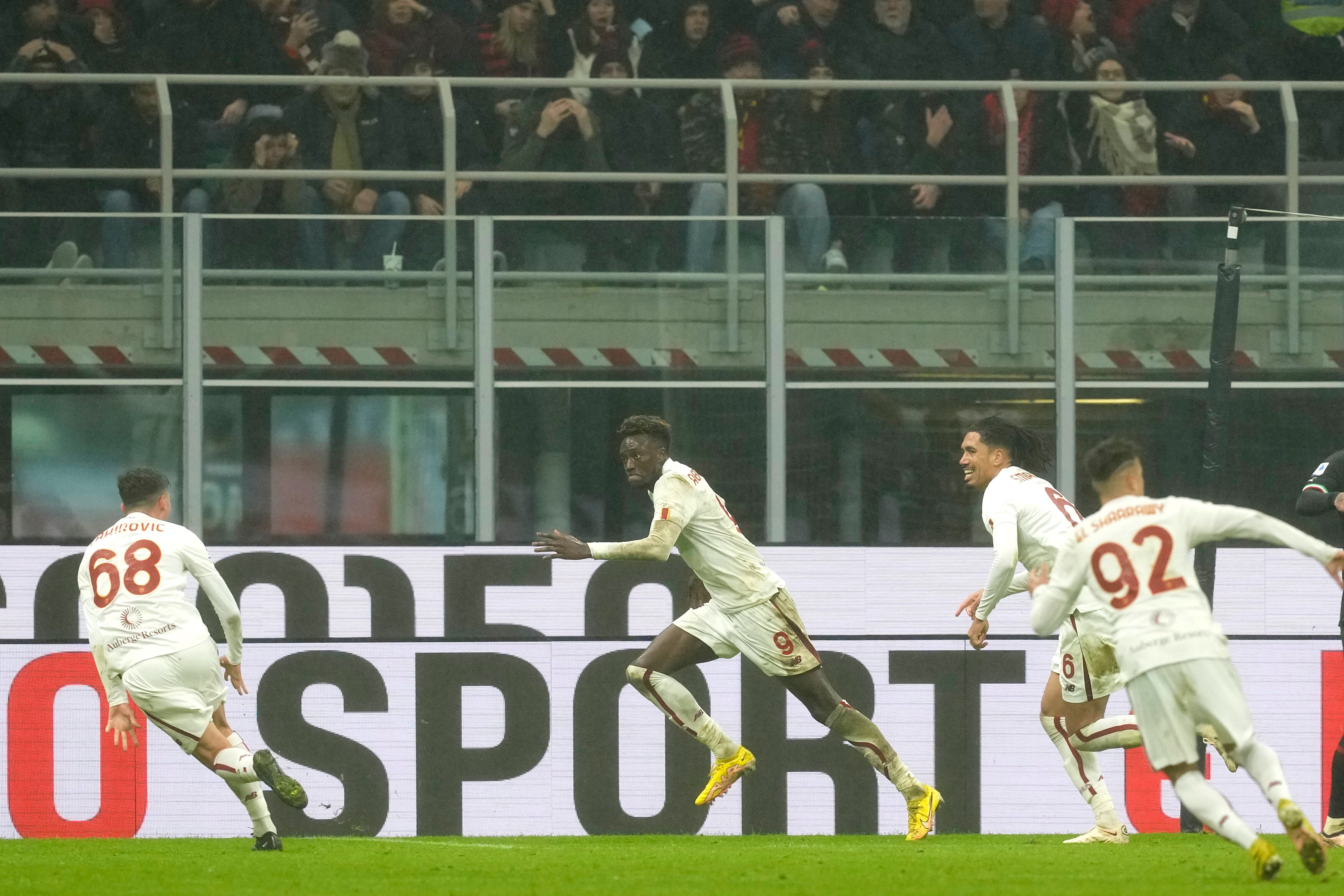 Roma's Tammy Abraham, centre, celebrates after scoring his side's second goal during the Serie A soccer match between AC Milan and Roma at the San Siro stadium, in Milan, Italy, Sunday, Jan. 8, 2023. (AP Photo/Antonio Calanni)