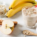 Apple and banana oatmeal smoothie raw helthy breakfast over background whit