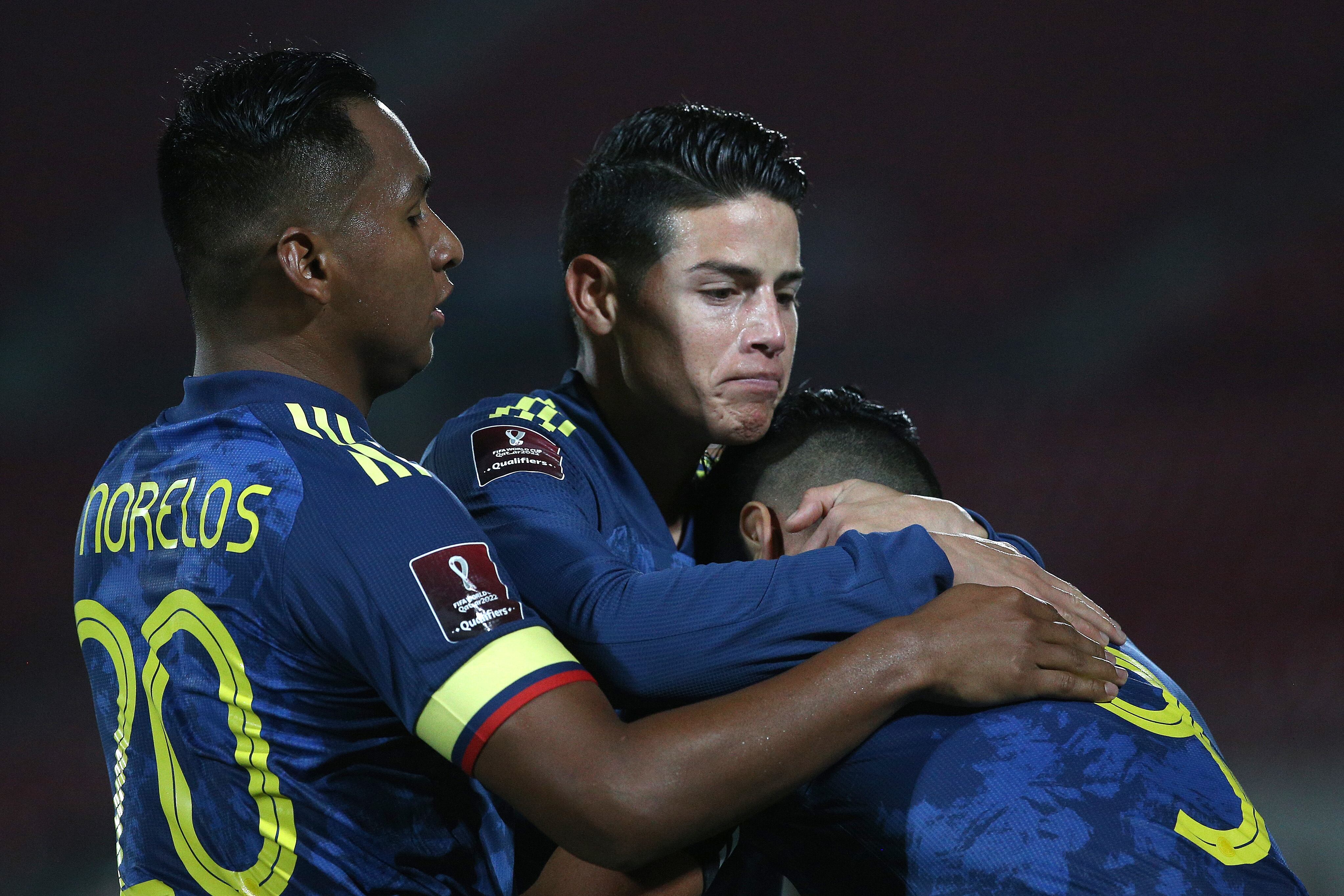 SANTIAGO, CHILE - OCTOBER 13: Radamel Falcao García of Colombia celebrates with teammates Alfredo Morelos and James Rodríguez after scoring the second goal of his team during a match between Chile and Colombia as part of South American Qualifiers for Qatar 2022 at Estadio Nacional de Chile on October 13, 2020 in Santiago, Chile. (Photo by Claudio Reyes - Pool/Getty Images)