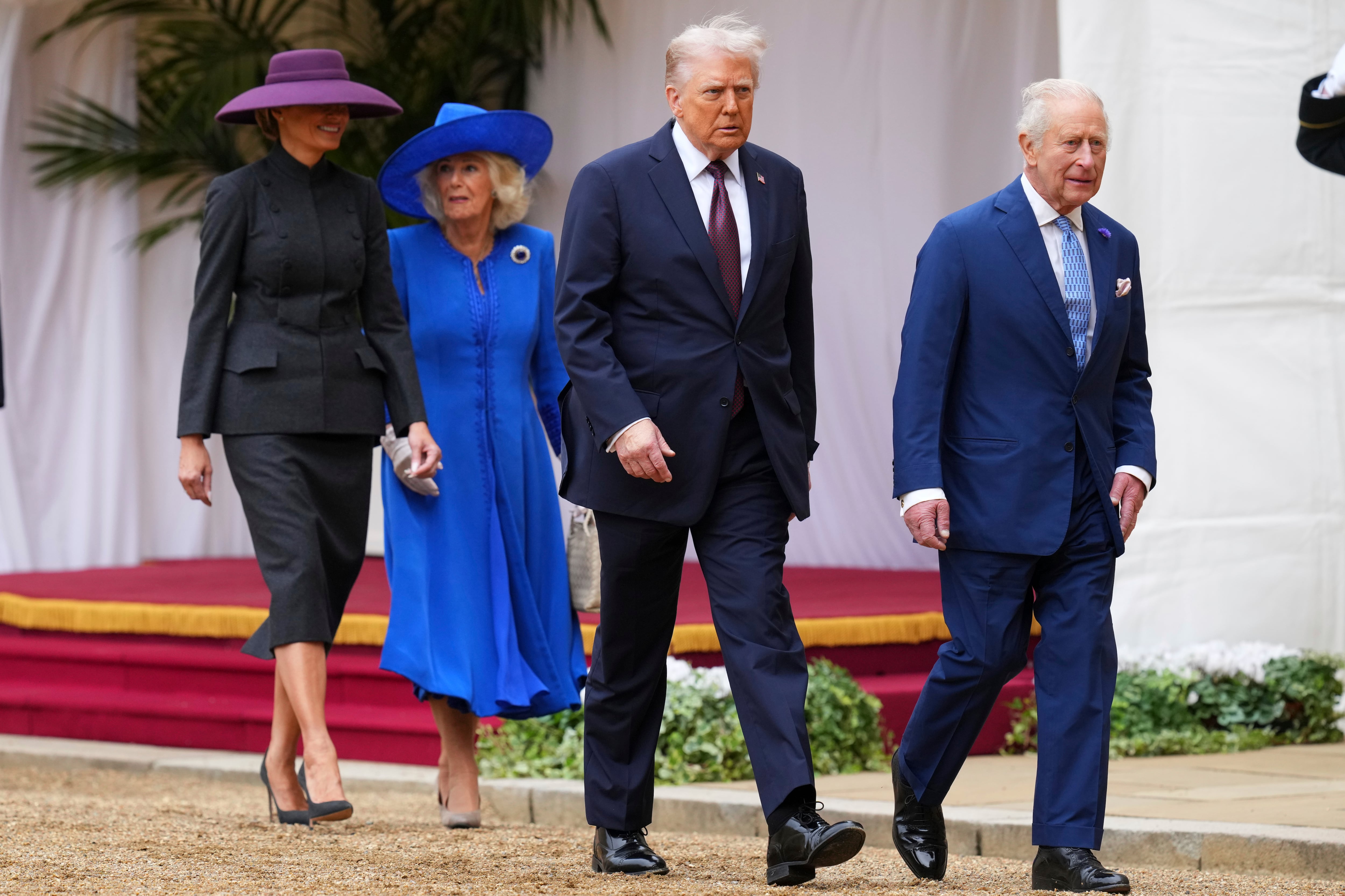 WINDSOR, ENGLAND - SEPTEMBER 17: President Donald Trump (2nd R), King Charles III (R), Queen Camilla (2nd L) and Melania Trump (L) walk to review the Guard of Honour at Windsor Castle on day two of the US President Donald Trump's second state visit to the UK on September 17, 2025 in Windsor, England. (Photo by Kirsty Wigglesworth - WPA Pool/Getty Images)