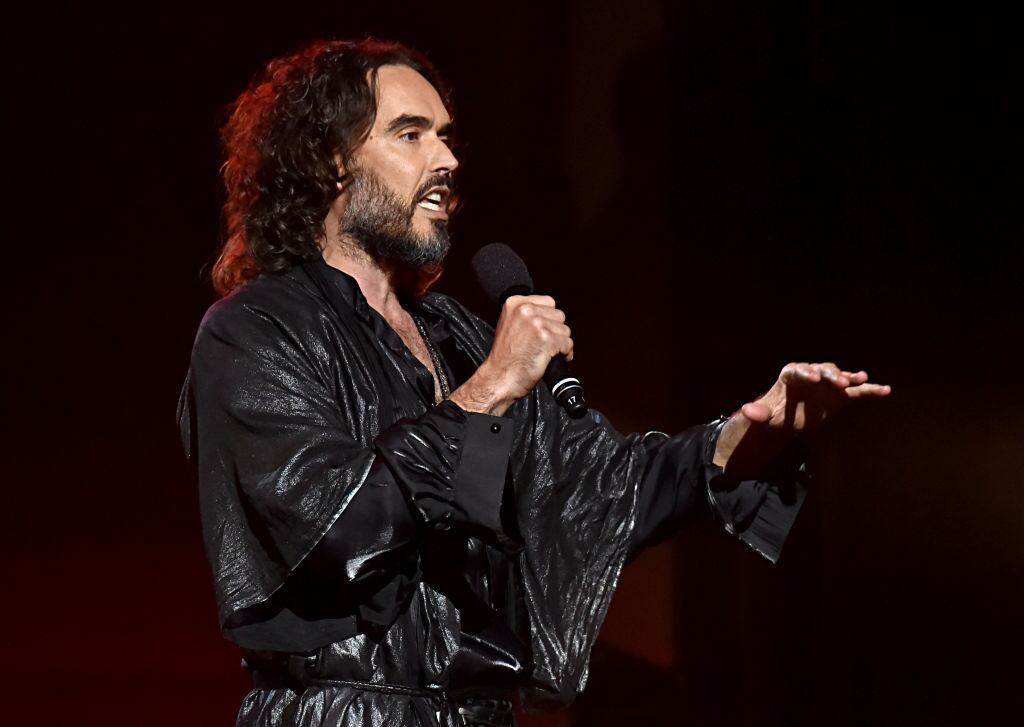 LOS ANGELES, CALIFORNIA - JANUARY 24: Russell Brand speaks onstage during MusiCares Person of the Year honoring Aerosmith at West Hall at Los Angeles Convention Center on January 24, 2020 in Los Angeles, California. (Photo by Lester Cohen/Getty Images for The Recording Academy )