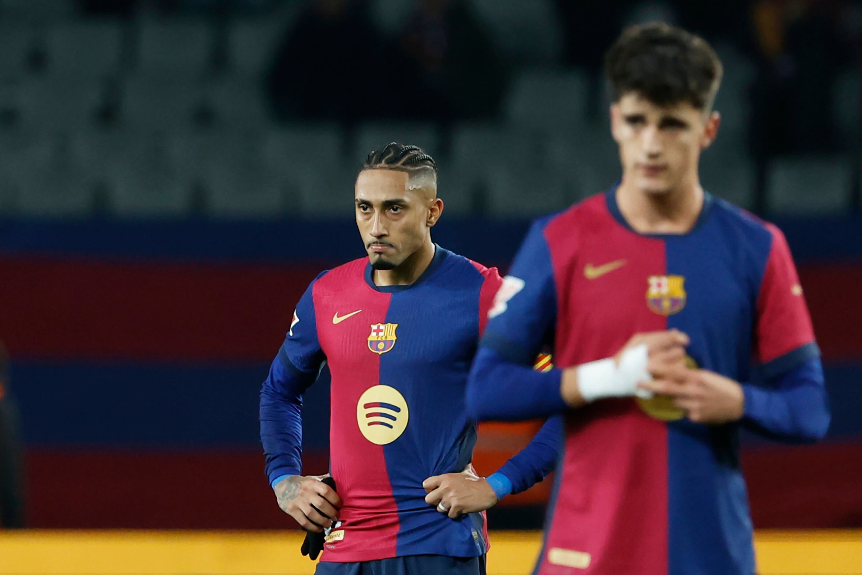 Barcelona's Raphinha, left, and Pau Victor react after the Spanish La Liga soccer match between Barcelona and Leganes at the Lluis Companys Olympic Stadium in Barcelona, Spain, Sunday, Dec. 15, 2024. (AP Photo/Joan Monfort)