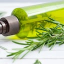 cosmetic creams and rosemary on white wooden table