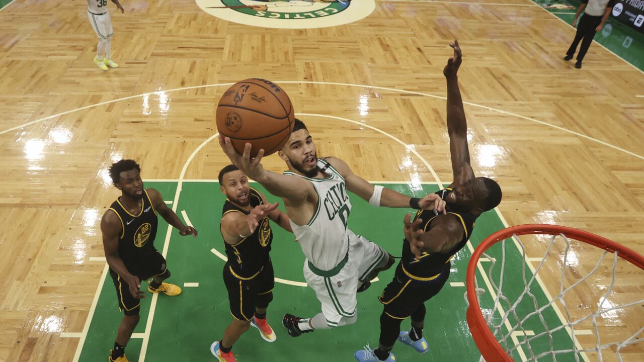 Boston Celtics forward Jayson Tatum (0) puts up a shot between Golden State Warriors' Stephen Curry and Draymond Green, right, during Game 3 of basketball's NBA Finals, Wednesday, June 8, 2022, in Boston. (Kyle Terada/Pool Photo vía AP)