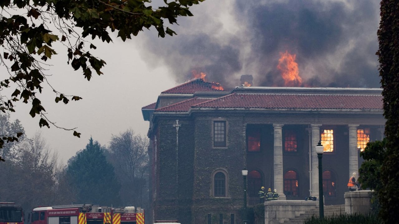 Los bomberos intentan extinguir un incendio en la Biblioteca Jagger de la Universidad de Ciudad del Cabo. El 18 de abril de 2021, un incendio forestal bajó por las faldas de la Montaña de la Mesa, incendiando edificios universitarios en Ciudad del Cabo. Foto de Rodger Bosch / AFP