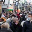 A shopping street is full of people in Cologne, Germany, Friday, Jan. 7, 2022. New corona measures are expected from a meeting of German governors and the federal government today to fight the COVID-19 pandemic. (AP Photo/Martin Meissner)