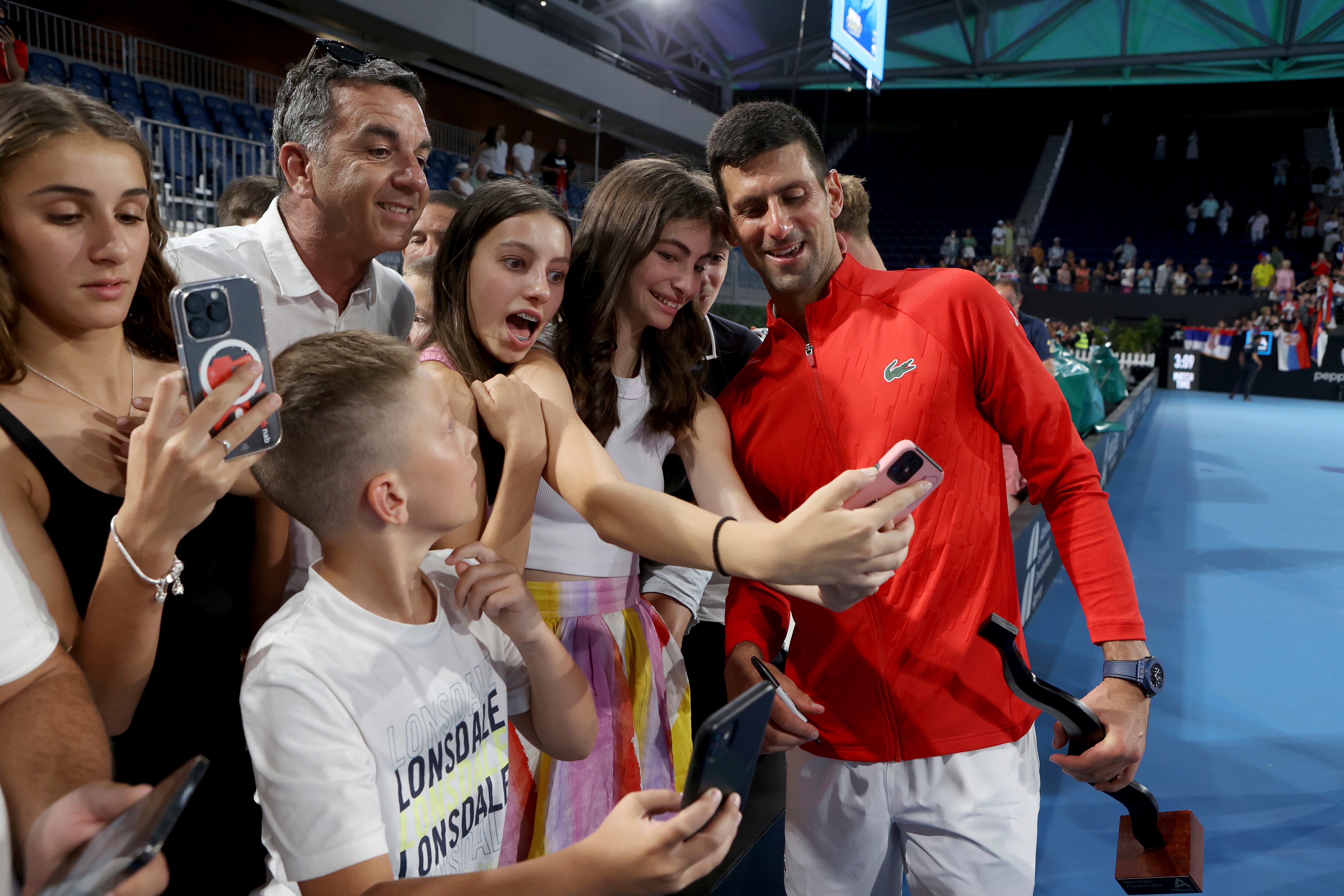 Serbia's Novak Djokovic poses for a selfie after winning the final of the Adelaide International tennis tournament against USA's Sebastian Korda in Adelaide, Australia, Sunday, Jan. 8, 2023. (AP Photo/Kelly Barnes)