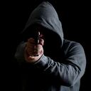 Man in green hoodie points gun