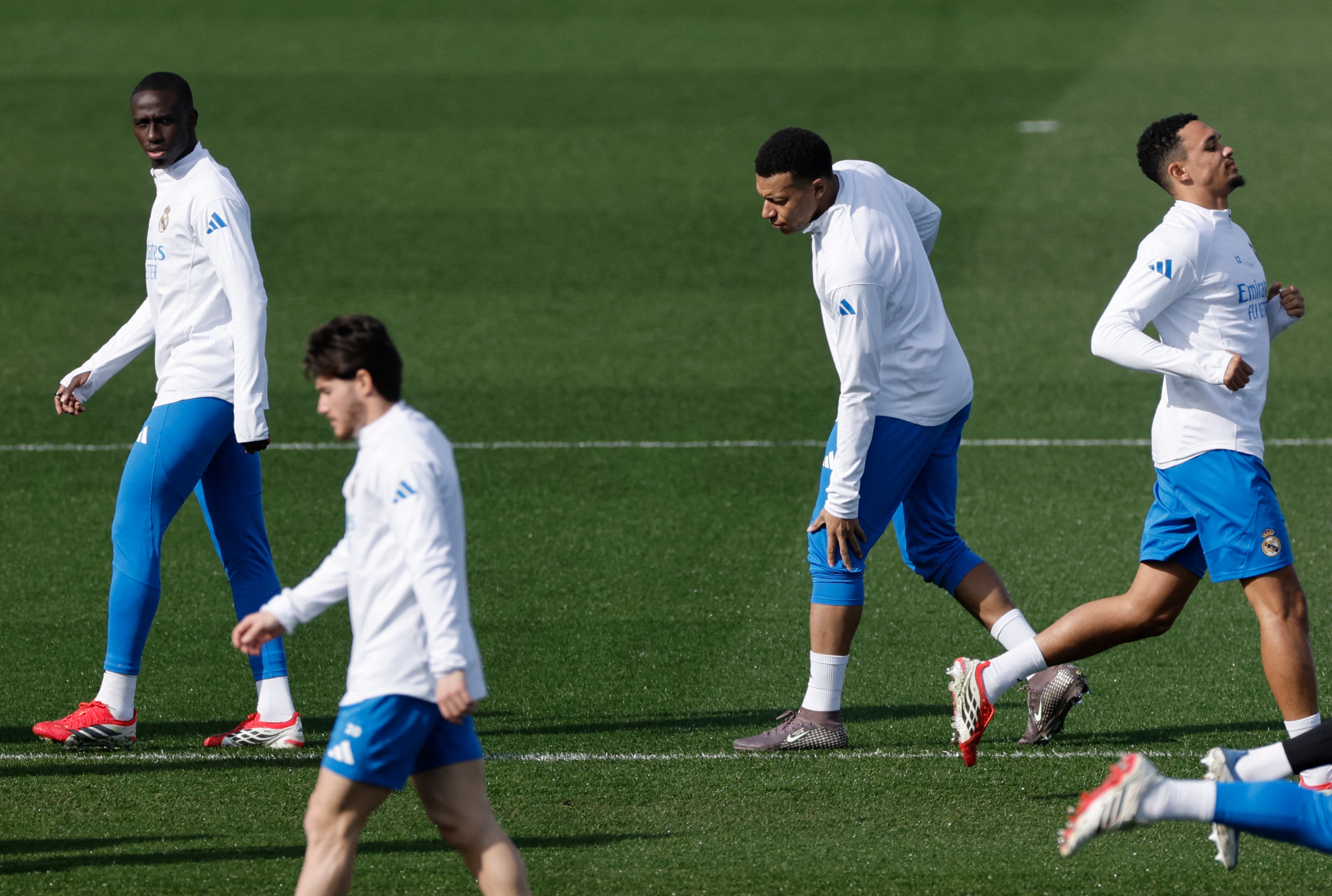 Real Madrid's French defender #23 Ferland Mendy (L) and Real Madrid's French forward #10 Kylian Mbappe (C) attend a training session on the eve of their UEFA Champions League knockout round play-off second leg football match against SL Benfica at Real Madrid Sports City in Valdebebas, in the outskirts of Madrid on February 24, 2026. (Photo by Oscar DEL POZO / AFP)