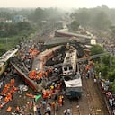 A drone shot of rescuers work at the site of passenger trains accident, in Balasore district, in the eastern Indian state of Orissa, Saturday, June 3, 2023. Rescuers are wading through piles of debris and wreckage to pull out bodies and free people after two passenger trains derailed in India, killing more than 280 people. Hundreds of others were trapped inside more than a dozen mangled rail cars, in one of the country's deadliest train crashes in decades. (AP Photo/Arabinda Mahapatra)