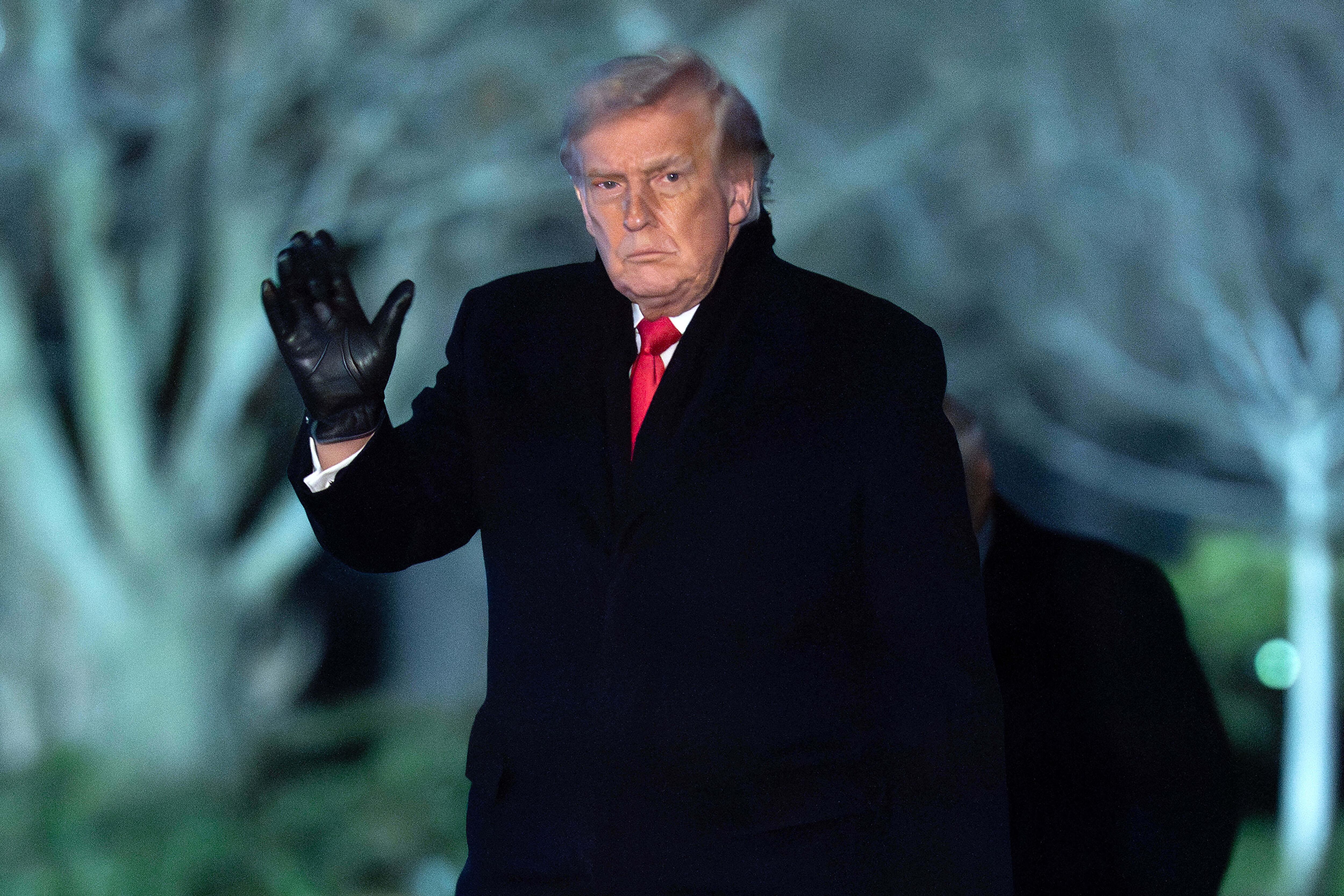 President Donald Trump waves to the media as he walks on the South Lawn of the White House, Tuesday, Jan. 20, 2026, in Washington. (AP Photo/Jose Luis Magana)