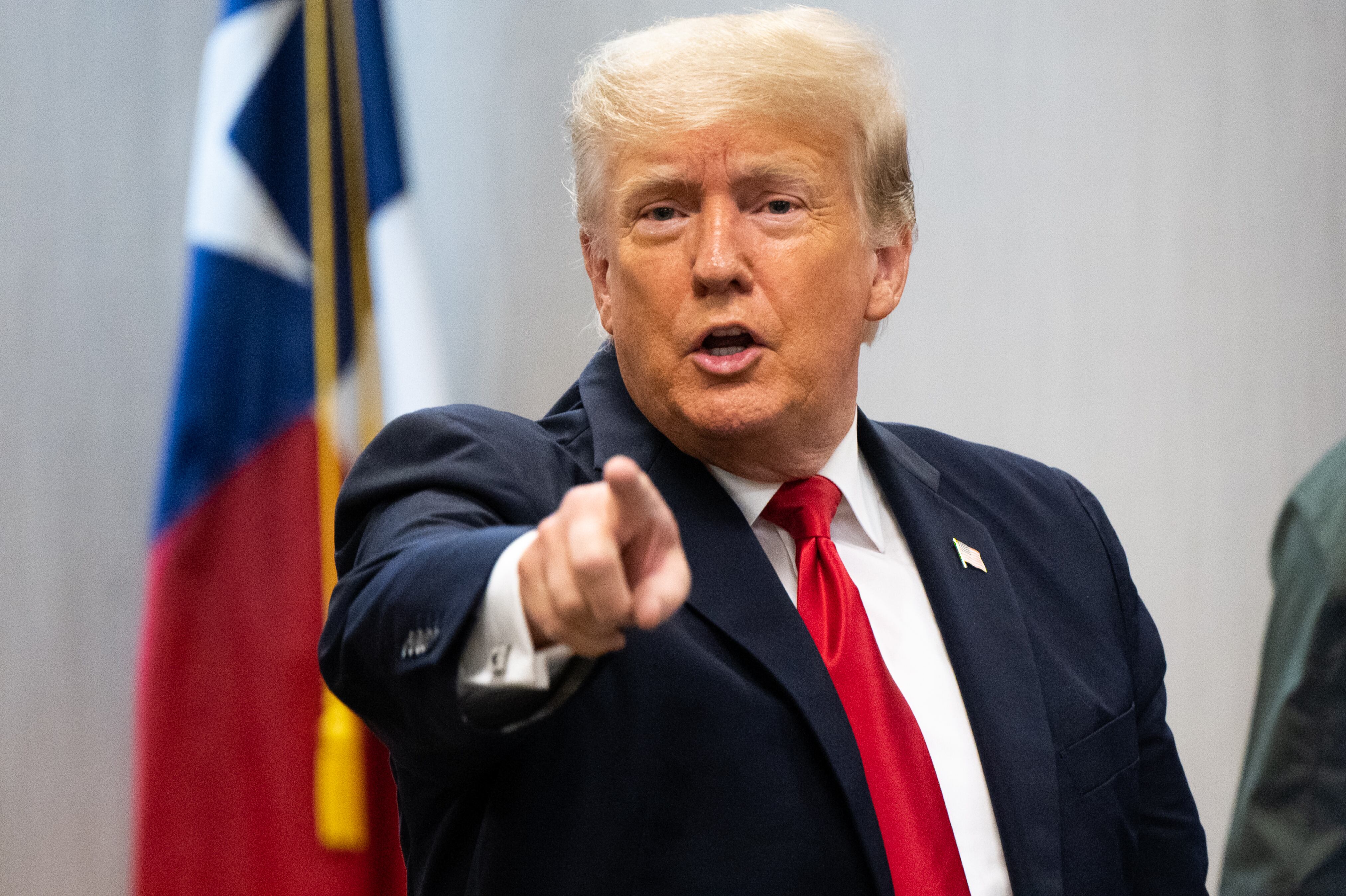WESLACO, TEXAS - JUNE 30: Former President Donald Trump addresses a member of the media after a border security briefing on June 30, 2021 in Weslaco, Texas. Gov. Greg Abbott has pledged to build a state-funded border wall between Texas and Mexico as a surge of mostly Central American immigrants crossing into the United States has challenged U.S. immigration agencies. So far in 2021, U.S. Border Patrol agents have apprehended more than 900,000 immigrants crossing into the United States on the southern border.  (Photo by Brandon Bell/Getty Images)