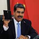 In this handout picture released by the Miraflores press office, Venezuela's President Nicolas Maduro shows a mobile gifted by Chinese President Xi Jinping while speaking during a conference with the international press in Beijing on September 14, 2023. Venezuelan President Nicolas Maduro has said his country could soon send its first astronauts to the Moon in a Chinese spacecraft, hailing on September 14 a scientific cooperation agreement reached with President Xi Jinping. (Photo by JHONN ZERPA / Venezuelan Presidency / AFP) / RESTRICTED TO EDITORIAL USE - MANDATORY CREDIT "AFP PHOTO / VENEZUELAN PRESIDENCY / Jhonn ZERPA" - NO MARKETING - NO ADVERTISING CAMPAIGNS - DISTRIBUTED AS A SERVICE TO CLIENTS