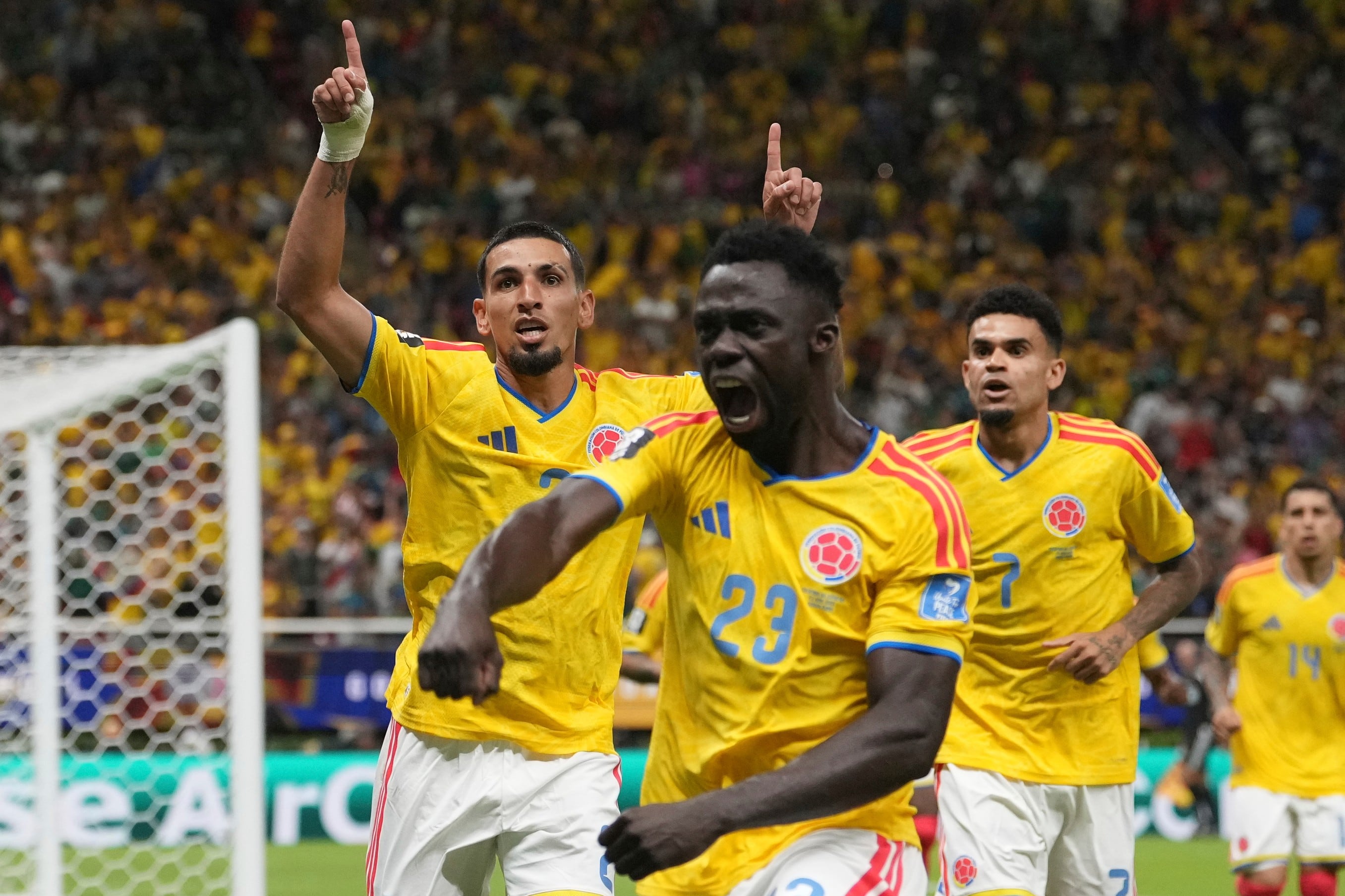 Colombia's Daniel Munoz (2) celebrates with his teammates Davinson Sanchez (23) and Luis Diaz (7) after scoring his side's opening goal during the World Cup Group K soccer match between Colombia and Congo in Zapopan, near Guadalajara, Mexico, Tuesday, June 23, 2026. (AP Photo/Fernando Llano)