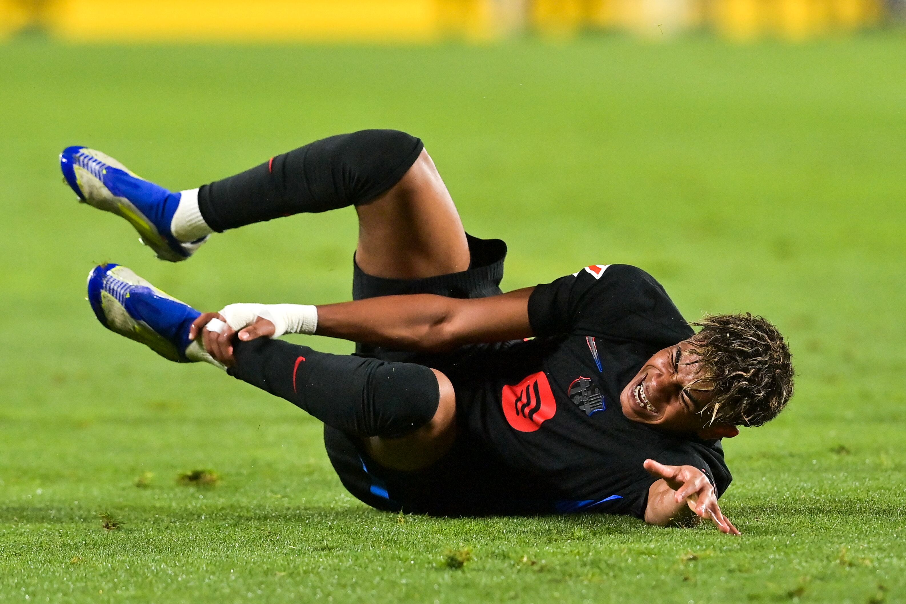 Barcelona's Spanish forward #19 Lamine Yamal grimaces after he was fouled during the Spanish league football match between UD Las Palmas and FC Barcelona at Gran Canaria Stadium in Las Palmas de Gran Canaria on February 22, 2025. (Photo by MANAURE QUINTERO / AFP)