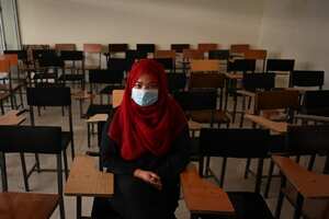 Un estudiante se sienta dentro de un aula después de que las universidades privadas reabrieran en Kabul el 6 de septiembre de 2021. - Las mujeres que asisten a universidades privadas afganas deben usar una bata abaya y un niqab que cubra la mayor parte de la cara, han ordenado los talibanes, y las clases deben estar segregadas por sexo - - o al menos dividido por una cortina. (Foto de Aamir QURESHI / AFP)