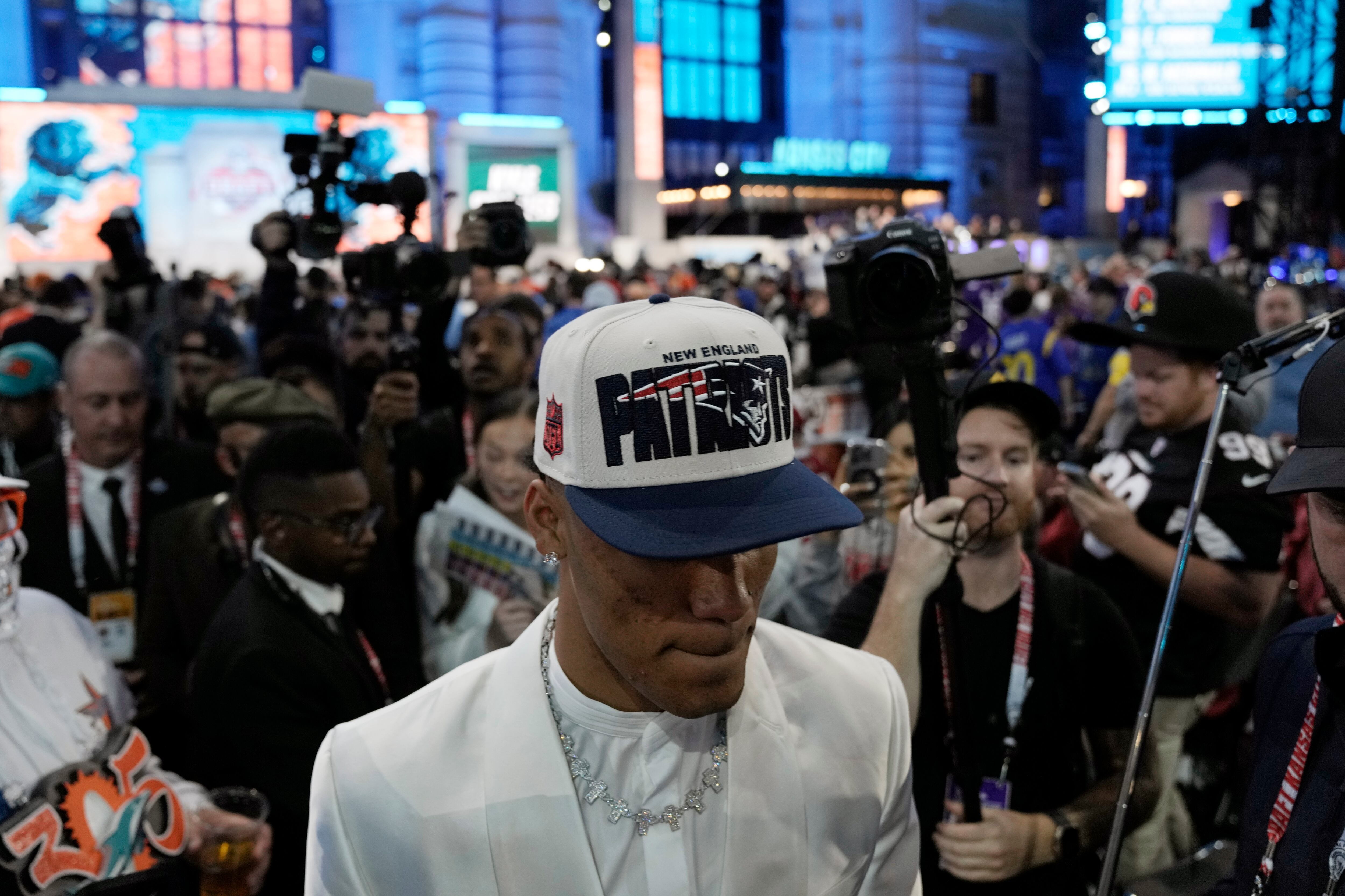 Oregon defensive back Christian Gonzalez walks through the crowd after being chosen by the New England Patriots with the 17th overall pick during the first round of the NFL football draft, Thursday, April 27, 2023, in Kansas City, Mo. (AP Photo/Charlie Riedel)