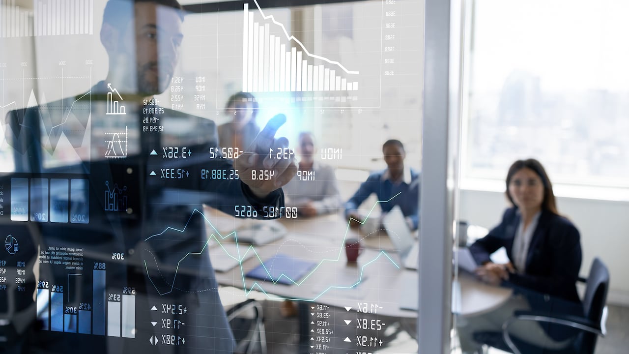 Successful Latin American man in a business meeting using an interactive screen while giving a presentation