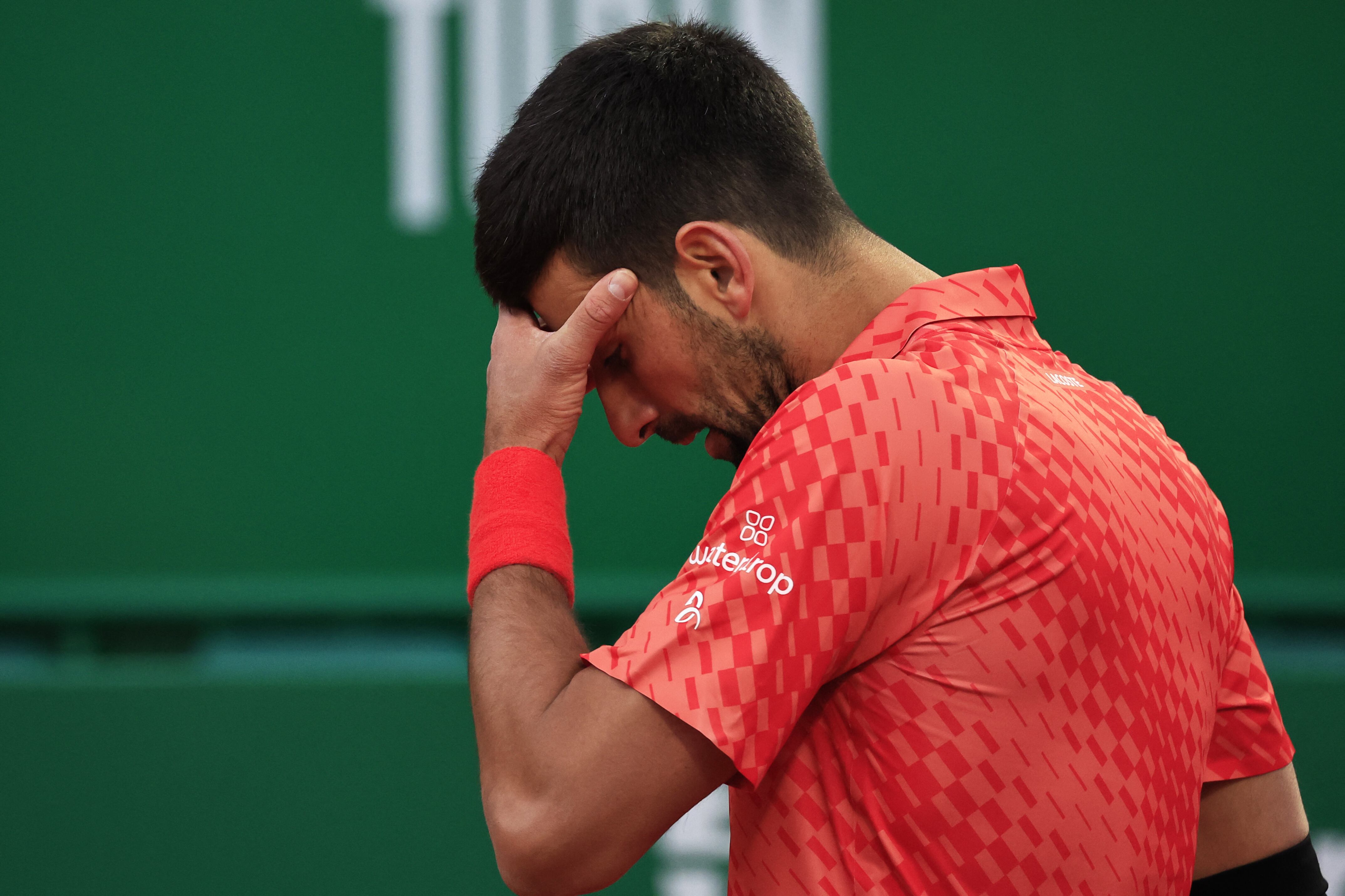 Serbia's Novak Djokovic reacts during his match against Italy's Lorenzo Musetti at the  Monte-Carlo ATP Masters Series tournament round of 16 tennis match in Monte Carlo on April 13, 2023. (Photo by Valery HACHE / AFP)