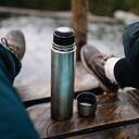 Young Caucasian couple drinking tea from thermos