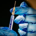 Syringe with vaccine against covid 19 ready to go. (fake graphic label)