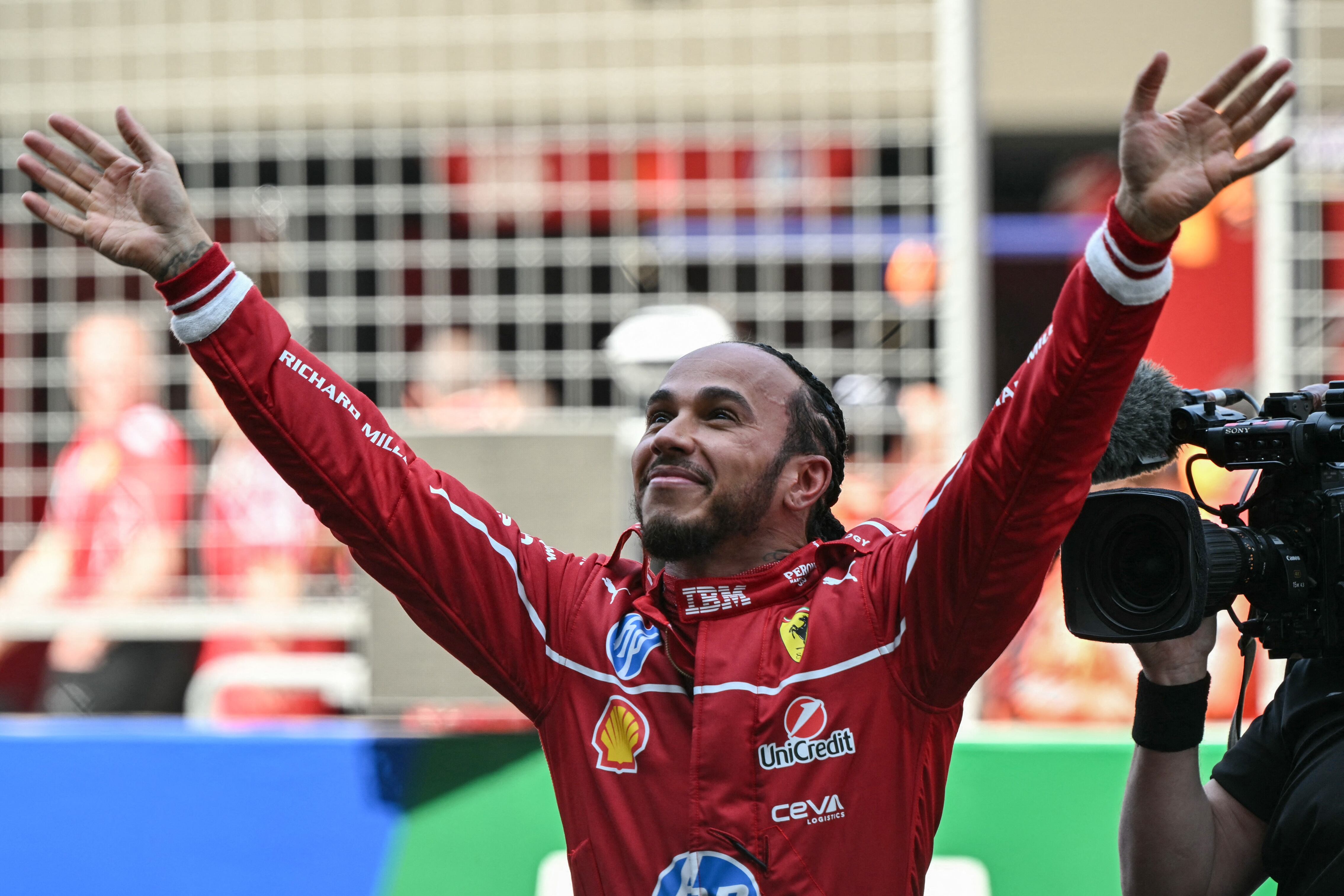 Ferrari's British driver Lewis Hamilton celebrates winning the sprint race of the Formula One Chinese Grand Prix at the Shanghai International Circuit in Shanghai on March 22, 2025. (Photo by Greg Baker / AFP)