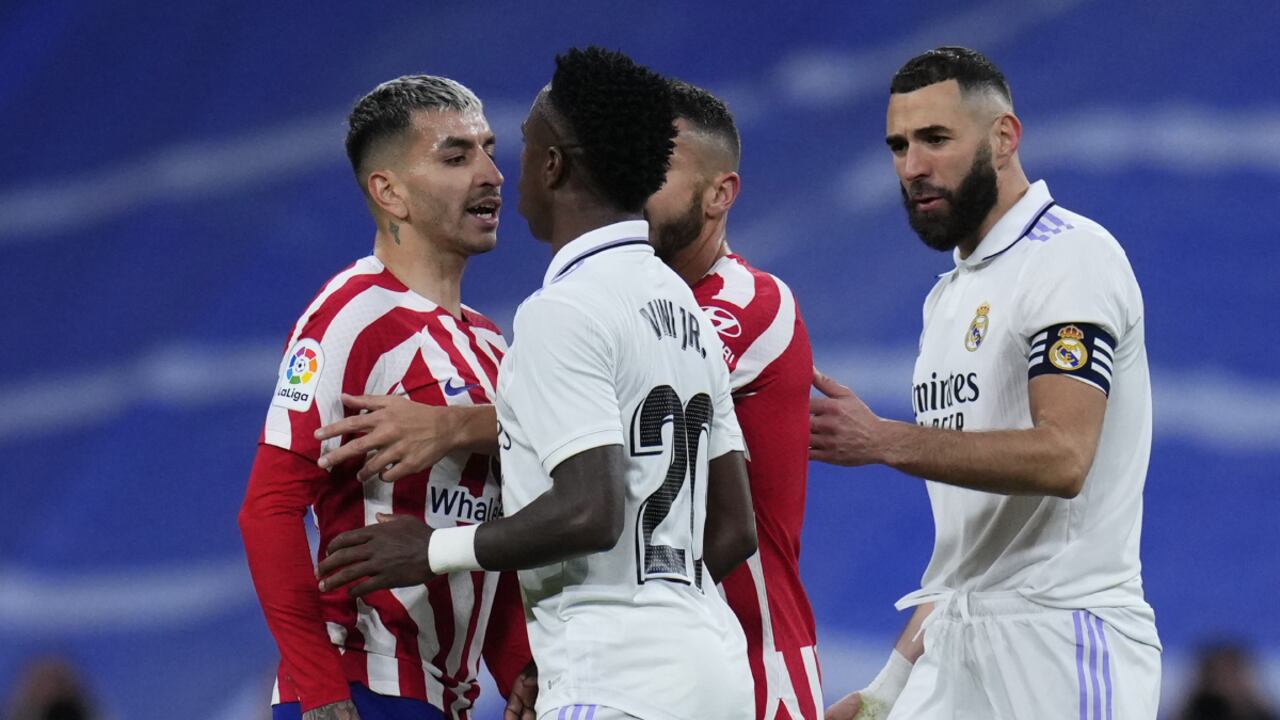 Real Madrid's Vinicius Junior, second left, scuffles with Atletico Madrid's Angel Correa, left, after receiving a red card during a Spanish La Liga soccer match between Real Madrid and Atletico Madrid at the Santiago Bernabeu stadium in Madrid, Spain, Saturday, Feb. 25, 2023. (AP/Manu Fernandez)
