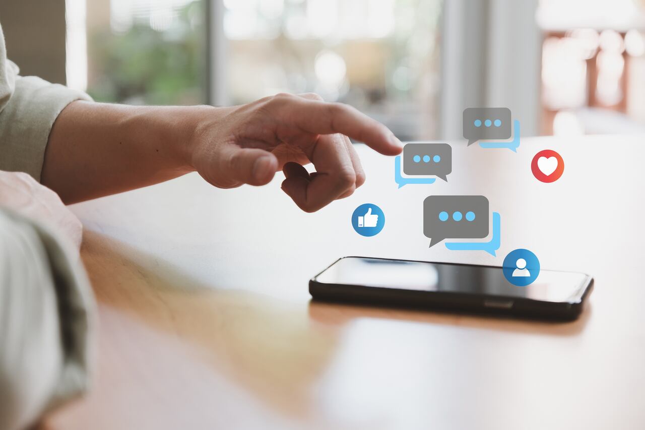 Selective focus at men hand while type on smartphone while chat and communication with friend on online social media platform. Virtual community that people can share or upload photo and content.