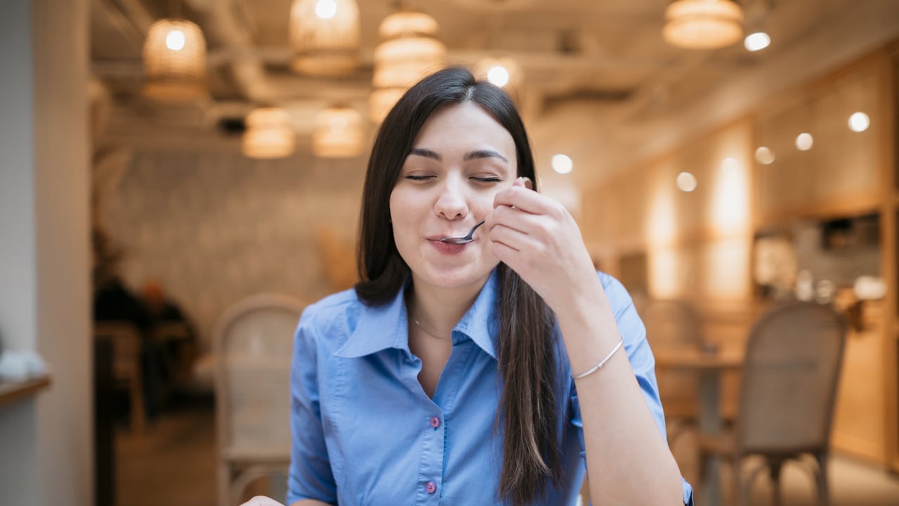 Joven feliz Feliz disfrutando en una cafetería.