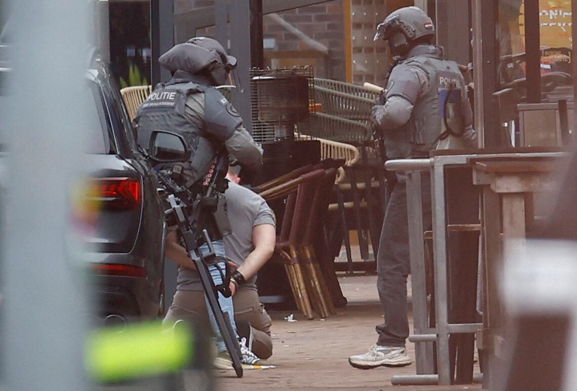 Agentes de policía holandeses detienen a una persona cerca del Café Petticoat, donde varias personas están siendo rehenes en Ede, Holanda, el 30 de marzo de 2024.