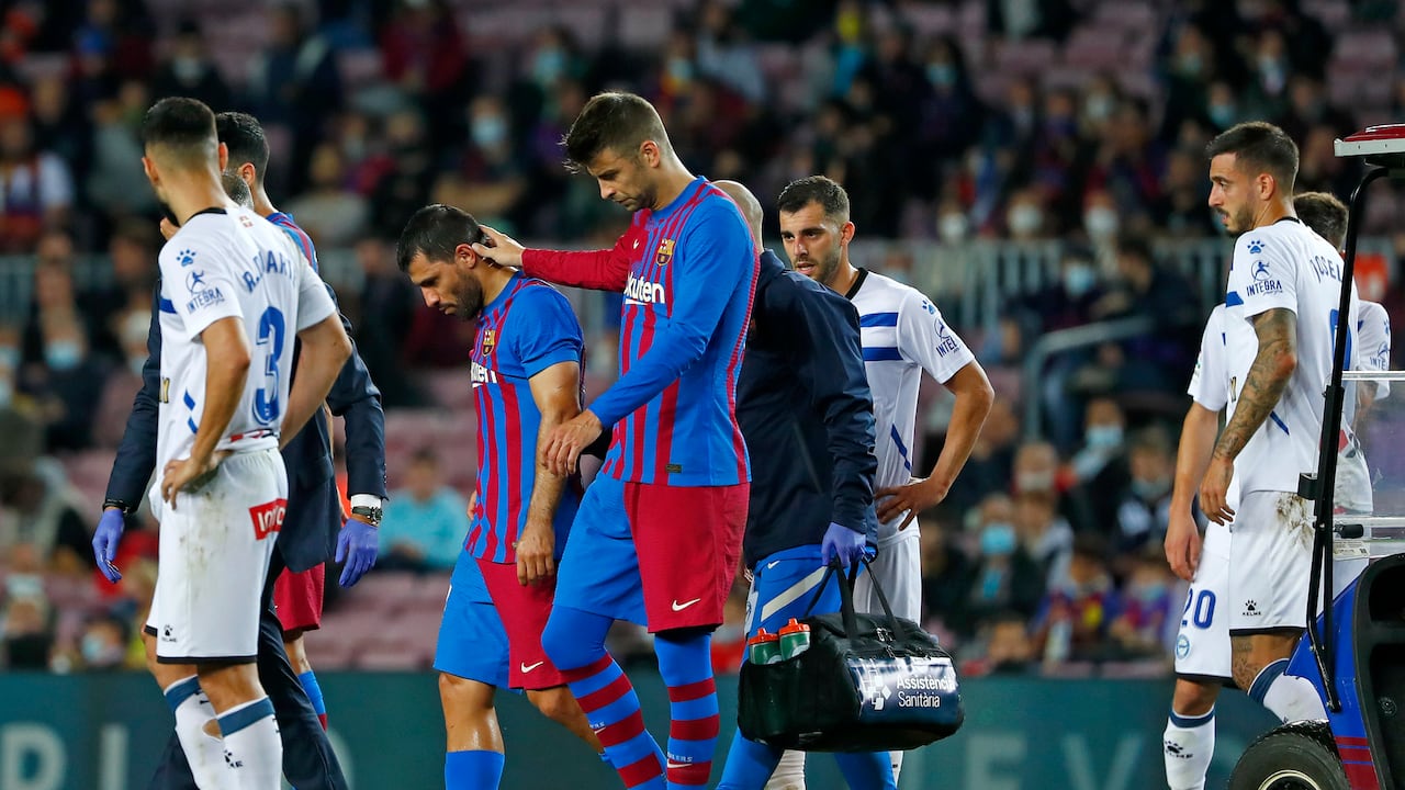 Barcelona's Sergio Aguero, second left, leaves the pitch injured during the La Liga soccer match between Barcelona and Alaves at the Camp Nou stadium in Barcelona, Spain Saturday, Oct. 30, 2021. (AP Photo/Joan Monfort)