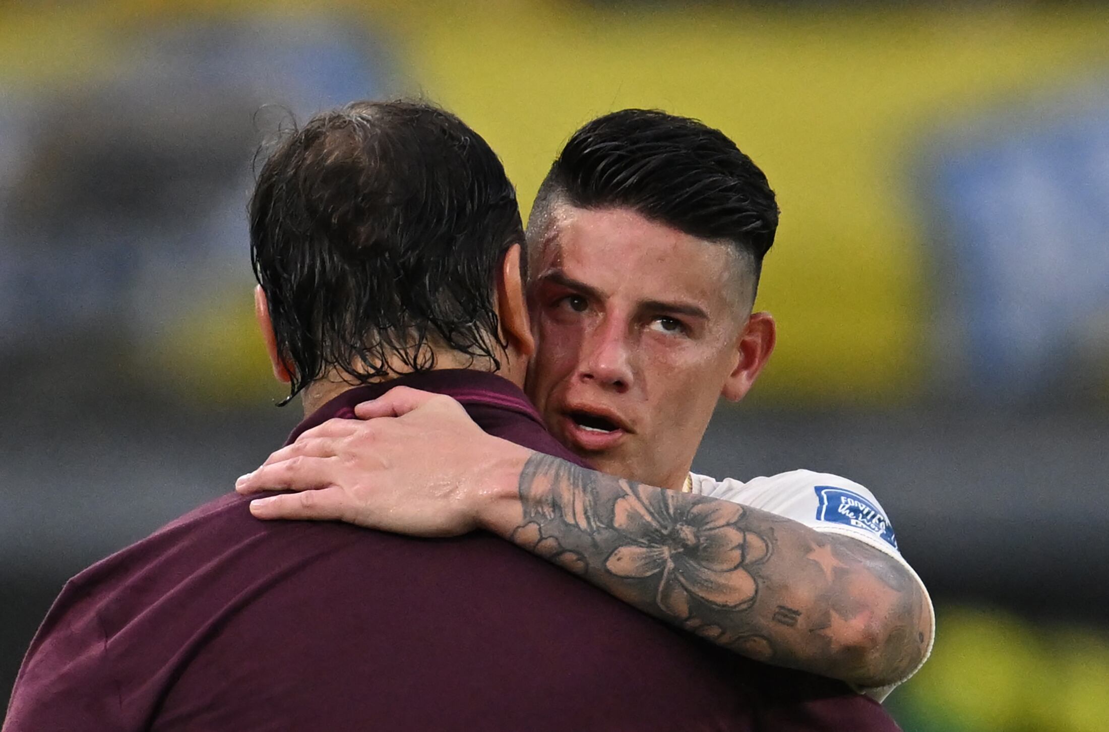 Colombia's midfielder #10 James Rodriguez is greeted by Colombia's Argentine coach Nestor Lorenzo after being replaced during the 2026 FIFA World Cup South American qualifiers football match between Colombia and Chile at the Roberto Melendez Metropolitan stadium in Barranquilla, Colombia, on October 15, 2024. (Photo by Raul ARBOLEDA / AFP)