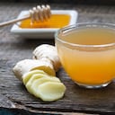 Ginger homemade tea infusion on wooden board with lemon still life