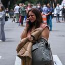 A woman speaks on her phone after an earthquake in Mexico City on September 19, 2022. - A 6.8-magnitude earthquake struck western Mexico on Monday, shaking buildings in Mexico City on the anniversary of two major tremors in 1985 and 2017, seismologists said. (Photo by RODRIGO ARANGUA / AFP)