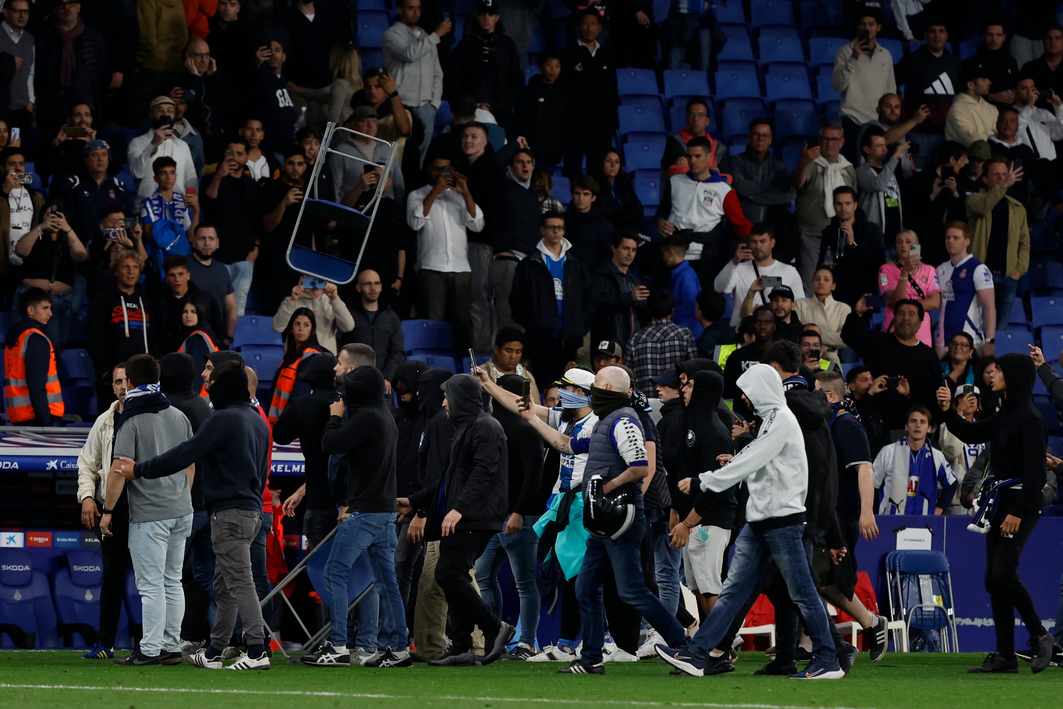 Supporters run in the file after the Spanish La Liga soccer match between Espanyol and Barcelona at the RCDE stadium in Barcelona, Sunday, May 14, 2023. (AP/Joan Monfort)
