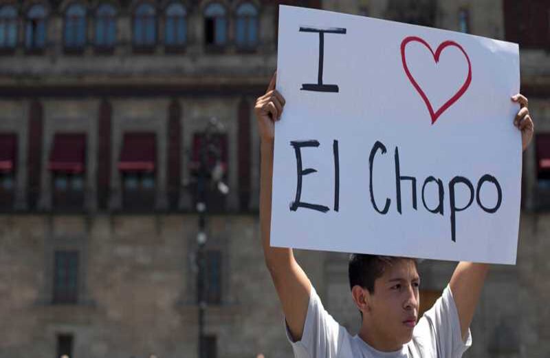 Un muchacho sostiene un cartel de apoyo a Joaquín el 'Chapo' Guzmán, afuera del Palacio Nacional en Ciudad de México. Una manifestación, principalmente de jóvenes, se tomó las instalaciones del gobierno mexicano para pedir que se respeten los derechos humanos del capturado capo de la droga. 