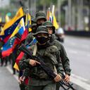 Members of military units and the Bolivarian National Guard participate in a military march and parade within the framework of military exercises called Bolivarian Shield "Supreme Commander Hugo Rafael Chavez Frias 2021," in Caracas on March 5, 2021. - Military units will develop military exercises from March 5 to 7. (Photo by Yuri CORTEZ / AFP)
