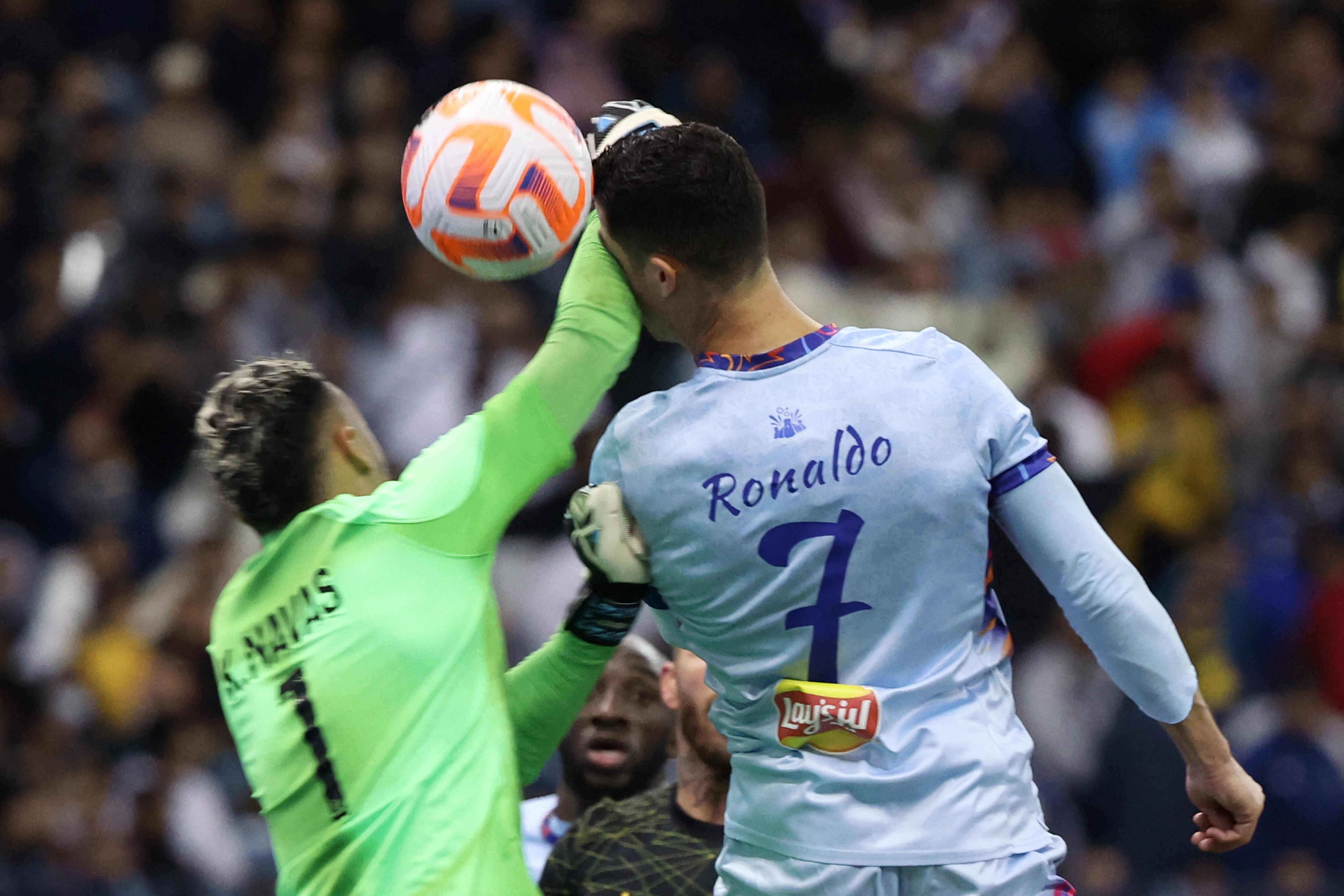 Riyadh All-Star's Portuguese forward Cristiano Ronaldo (R)collides with Paris Saint-Germain's Costa Rican goalkeeper Keylor Navas (L) during the Riyadh Season Cup football match between the Riyadh All-Stars and Paris Saint-Germain at the King Fahd Stadium in Riyadh on January 19, 2023. (Photo by Giuseppe CACACE / AFP)