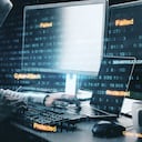 Hacker at desktop using computer with stock data. Trade and hacking concept.